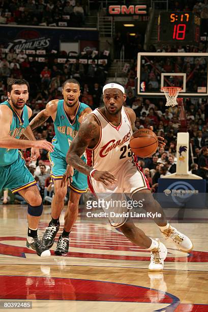 LeBron James of the Cleveland Cavaliers drives to the basket against Peja Stojakovic and Tyson Chandler of the New Orleans Hornets on March 26, 2008...