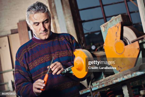 real mature repairman in workshop - home business garage stock pictures, royalty-free photos & images