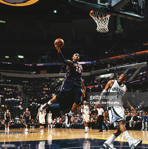 Vince Carter of the New Jersey Nets goes for a layup against Kyle Lowry of the Memphis Grizzlies during the game at the FedExForum on March 5, 2008...