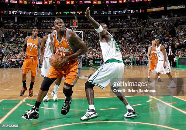 Shaquille O'Neal of the Phoenix Suns goes for the shot against Kevin Garnett of the Boston Celtics on March 26, 2008 at the TD Banknorth Garden in...