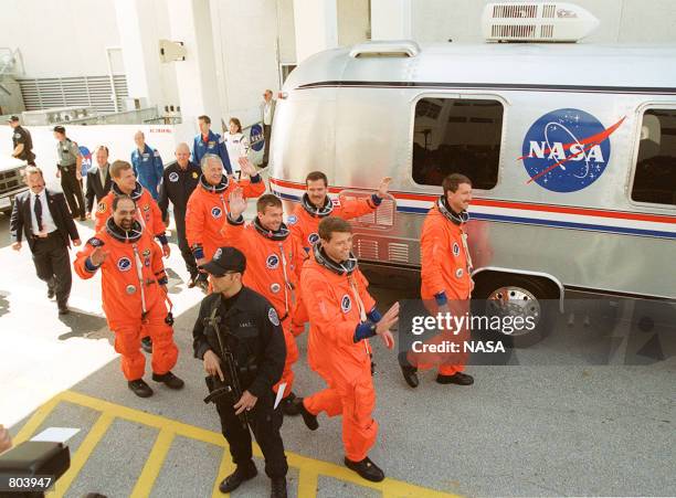 Leaving the Operations and Checkout Building, the STS-100 crew waves to well-wishers and heads to the Astrovan for transport to Launch Pad 39A, April...