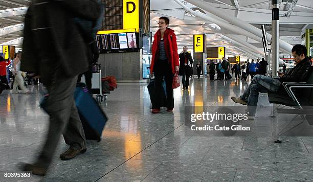 Passengers make their way to check-in in the departures area of Terminal 5 on March 27, 2008 in London, England. Terminal 5 opens to the public for...