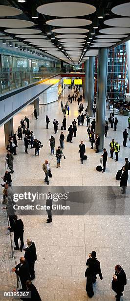 Members of the public wait for passengers to arrive at the International Arrivals in Terminal 5 on March 27, 2008 in London, England. Terminal 5...