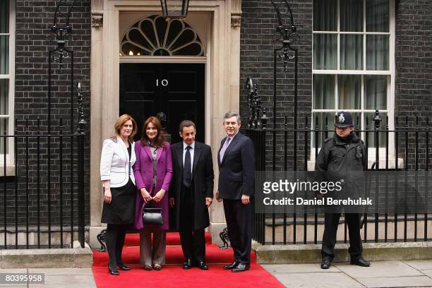 French President Nicolas Sarkozy and wife Carla Bruni-Sarkozy are greeted by British Prime Minister Gordon Brown and wife Sarah outside of their...