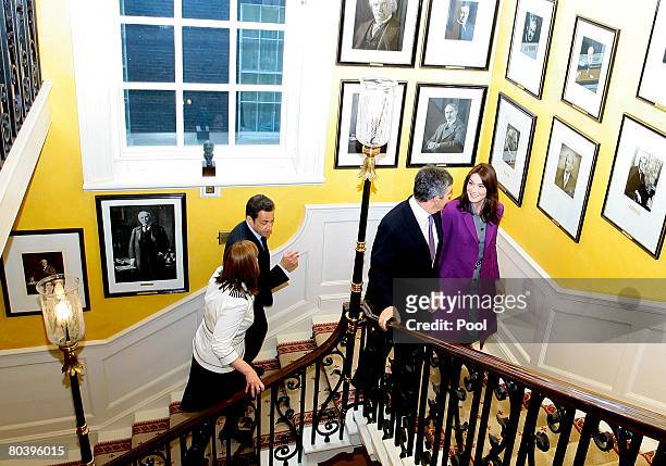 Sarah Brown, French President Nicolas Sarkozy, British Prime Minister Gordon Brown and Carla Bruni-Sarkosy walk up the stairs past portraits of...