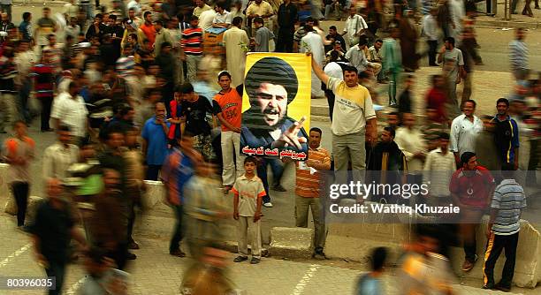 Iraqi supporters of Shiite cleric Moqtada al-Sadr carry his picture on March 27, 2008 during a protest in the Sadr city Shiite district in Baghdad,...