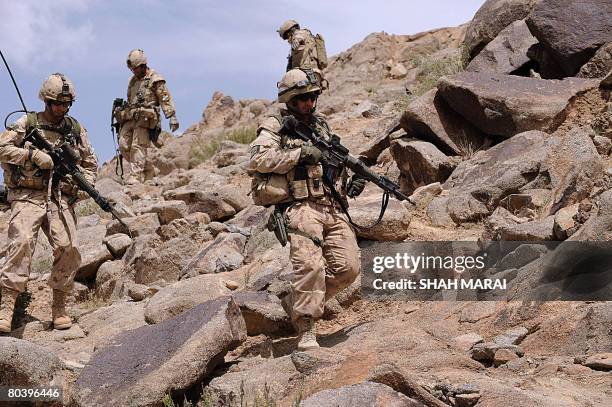 Canadian soldiers with the NATO-led International Security Assistance Force walk during a patrol at Shah Wali Kot district some 35 km north of...