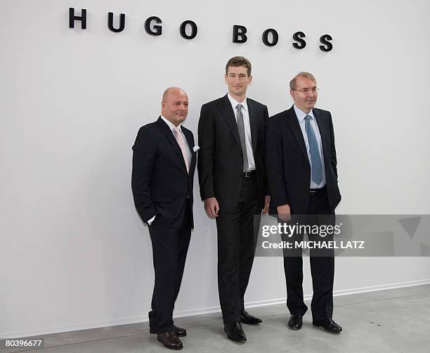 Members of the board of management of German fashion maker Hugo Boss AG Andre Maeder, Joachim Reinhardt and Hans Fluri pose for a picture on March...