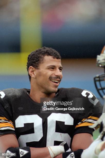 Defensive back Rod Woodson of the Pittsburgh Steelers smiles while talking to teammates on the sideline during a game against the New Orleans Saints...