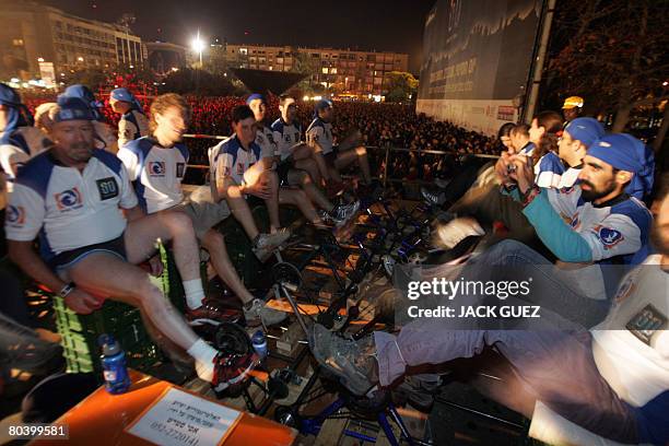 Israelis pedal to generate electricity to power a concert in Tel Aviv on March 27 as part of a worldwide "lights-off" campaign to raise awareness of...