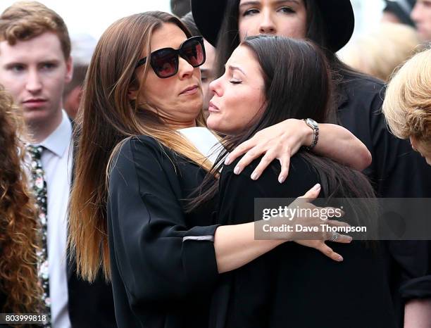 Coronation Street actor Kym Marsh hugs a fellow mourner at the end of the funeral of Martyn Hett at Stockport Town Hall on June 30, 2017 in...