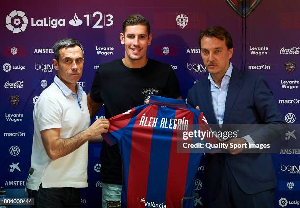 Levante UD Unveil New Signing Alex Alegria poses with a t-shirt beside Quico Catalan and Carmelo del Pozo during his presentation at Ciutat de...