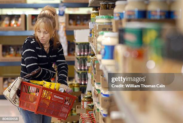 Chrystal Kennery, of New Holland, Pennsylvania shops at Amelia's Grocery Outlet, a "surplus" or "salvage" grocer that buys manufacturers' closeouts,...