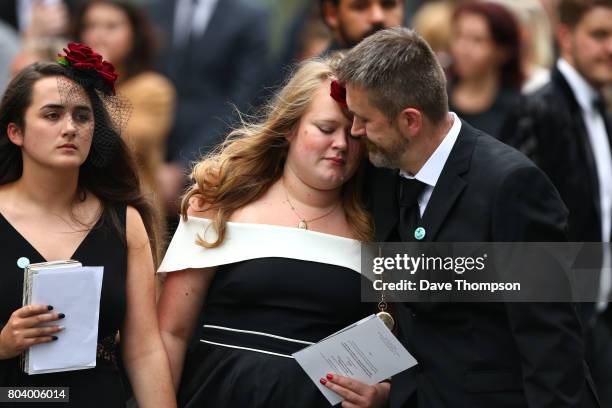 Martyn Hett's stepfather Stuart Murray comforts a mourner as they leave the funeral of Martyn Hett at Stockport Town Hall on June 30, 2017 in...