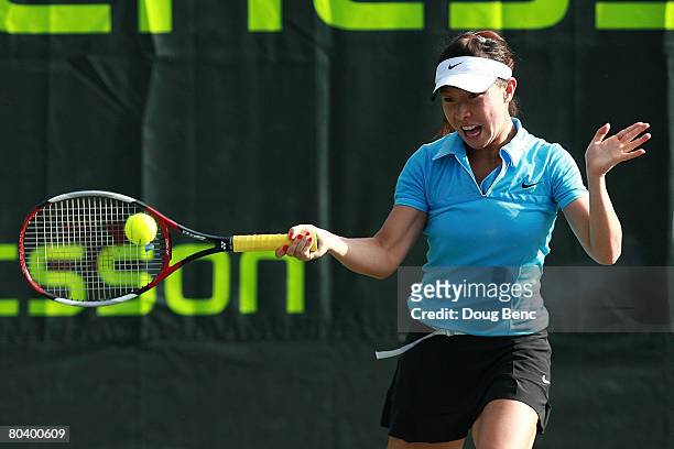 Jie Zheng of China returns a shot against Galina Voskoboeva of Russia during day four of the Sony Ericsson Open at the Crandon Park Tennis Center on...