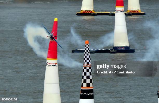Czech Petr Kopfstein flies over the Danube river with his Zivko Edge 540 plane during the practice session of the Red Bull Air Race World...