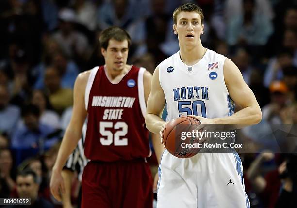 Tyler Hansbrough of the North Carolina Tar Heels reacts after a turnover as he stands in front of Caleb Forrest of the Washington State Cougars...