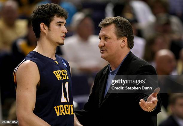Head coach Bob Huggins of West Virginia Mountaineers talks to player Joe Alexander during the first half of the West Regional Sweet 16 game against...