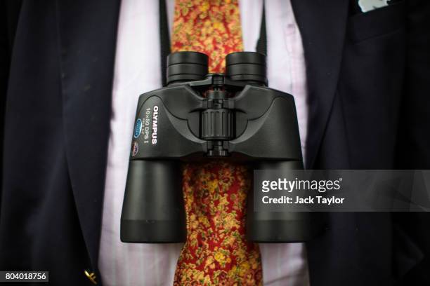 Binoculars hang around the neck of a spectator at the Henley Regatta on June 30, 2017 in Henley-on-Thames, England. The five day Henley Royal Regatta...