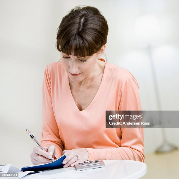 Woman Writecheck Woman Writing Check High-Res Stock Photo - Getty Images