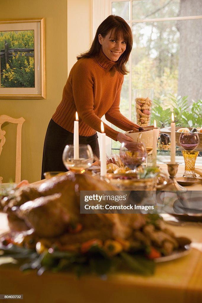 Woman setting table for holiday meal