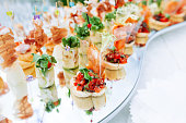 Beautifully decorated catering banquet table with different food snacks and appetizers