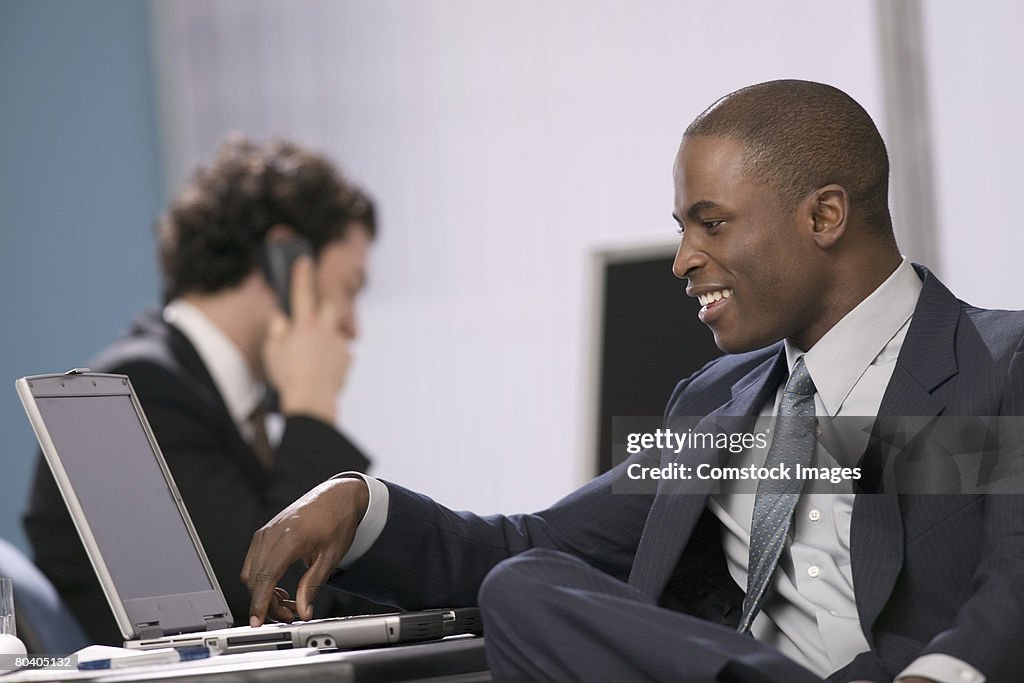 Smiling businessman with laptop