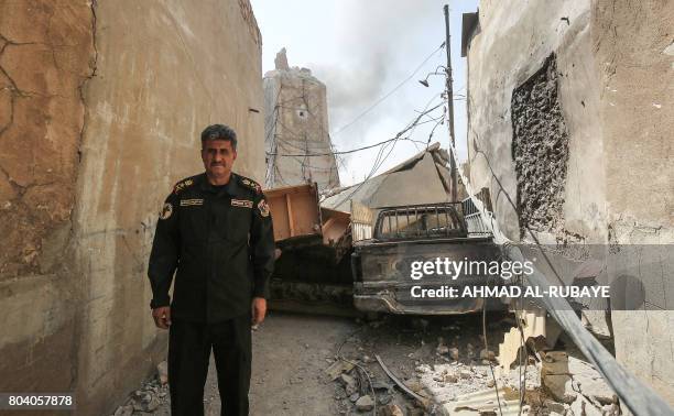 Iraqi Counter-Terrorism Services chief of staff, Lieutenant-General Abdul-Wahab al-Saadi, poses for a picture with the background showing the base of...