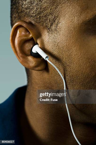 man wearing ear buds - human ear stock pictures, royalty-free photos & images