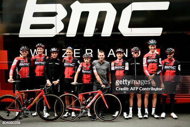 Retired Australia's cyclist, BMC's former rider, Cadel Evans poses for photographers with riders of the USA's BMC Racing cycling team Belgium's Greg...