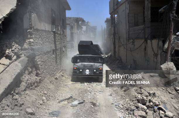An Iraqi Counter-Terrorism Service humvee advances through a street in the Old City of Mosul on June 30, 2017 during as the offensive to recapture...