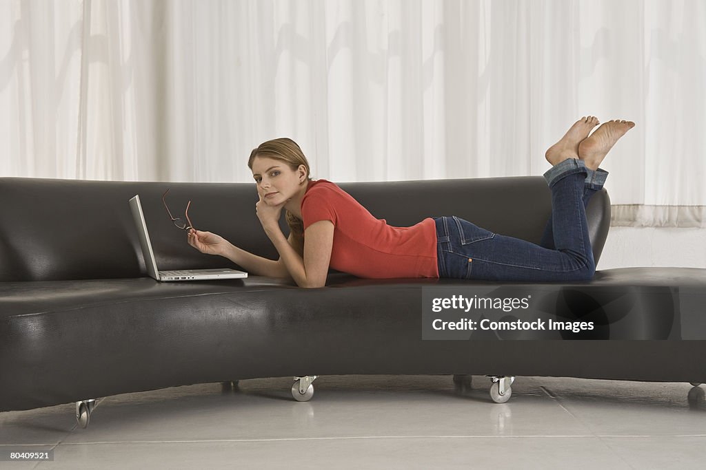 Relaxed woman using laptop at home