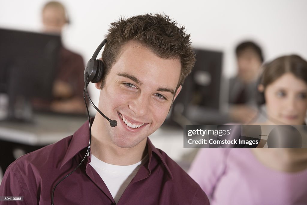 Smiling telemarketer with headset