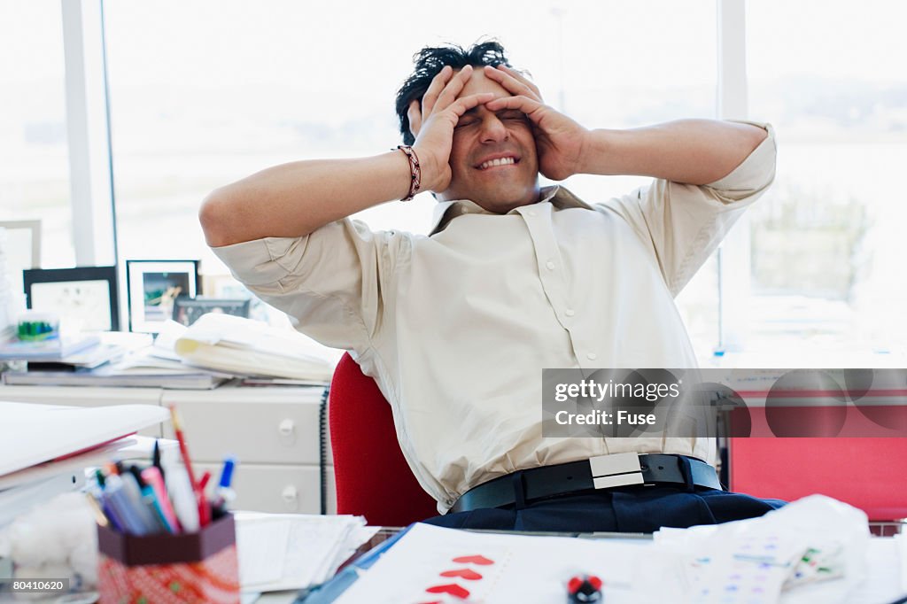 Businessman with Head in Hands