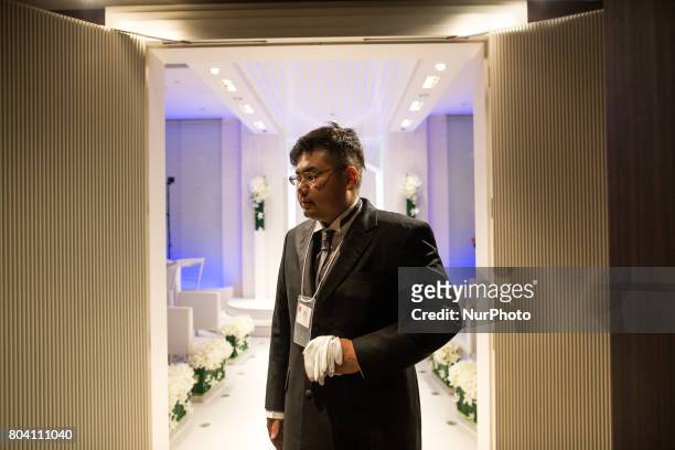 Anime fan walks out of a chapel after his wedding ceremony in Tokyo, Japan on June 30, 2017. A marketing event by Japanese video game maker Hibiki...
