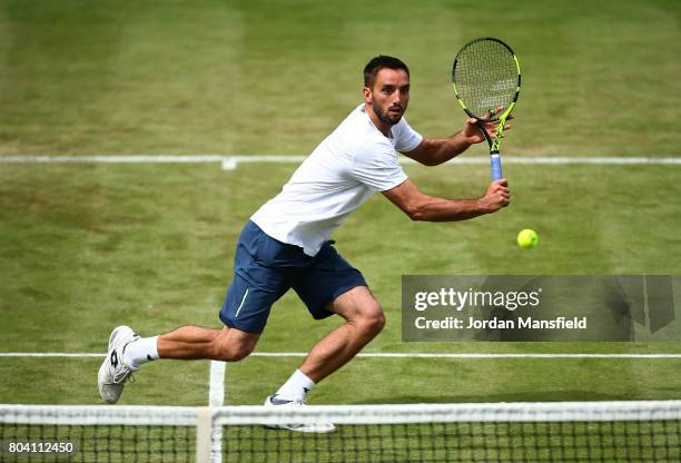 Viktor Troicki of Serbia reaches for a backhand during his match against Nick Kyrgios of Australia during day four of The Boodles Tennis Event at...