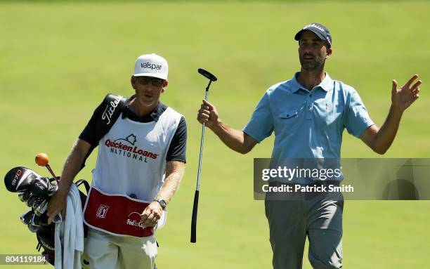 Geoff Ogilvy of Australia and his caddie walk on the fifth hole during the second round of the Quicken Loans National on June 30, 2017 TPC Potomac in...