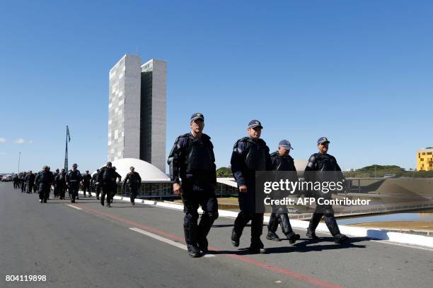 Military policemen reinforce security in front of the National Congress, in Brasilia, on June 30 before a demonstration organized by unions against...
