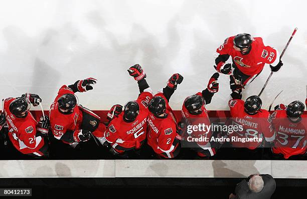 Chris Neil of the Ottawa Senators celebrates a goal against the Buffalo Sabres at the players' bench at Scotiabank Place March 27, 2008 in Ottawa,...