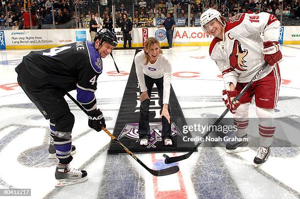 Cammi Granato, captain of the 1998 United States women's Olympic gold medal hockey team, drops the ceremonial puck between team captains Rob Blake of...