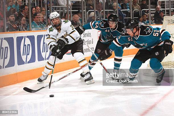 Stephane Robidas of the Dallas Stars, works the puck around Marc-Edouard Vlasic and Brian Campbell of the San Jose Sharks during a NHL game on March...