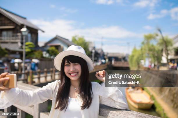 happy young woman taking picture on old wooden bridge - 2017 20 stock pictures, royalty-free photos & images