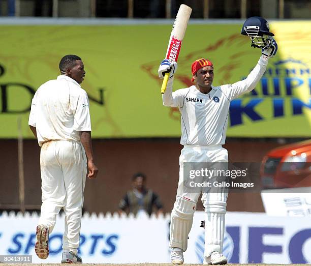 Virender Sehwag of India celebrates his 200 runs with Makhaya Ntini looking on during day 3 of the 1st test match between India and South Africa held...