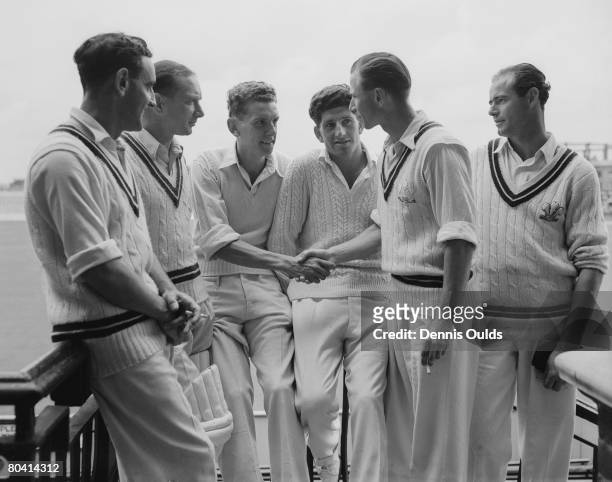 Surrey medium bowler Peter Loader is congratulated by teammate David Fletcher, while Bernie Constable, Arthur McIntyre, Ken Barrington and John...