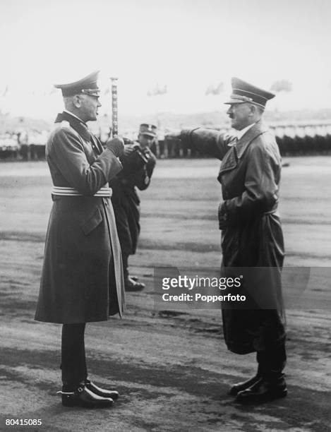 Adolf Hitler salutes Field Marshal Werner von Blomberg during a military review in Zeppelin Field, Nuremberg, at the end of the Nazi Party Congress,...