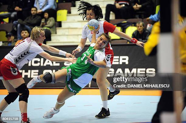 Verten Orsolya from Hungary shots at the gate between Poland's Malgorzata Majerek and Dorota Malczewska during the women handball 2008 Olympic...