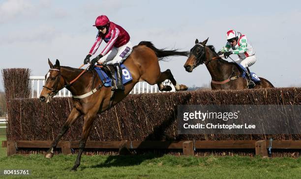 Jockey P J Brennan riding Island Flyer jumps the final hurdle in the lead to win The Montpelier Re Novices Handicap Steeple Chase at Newbury...