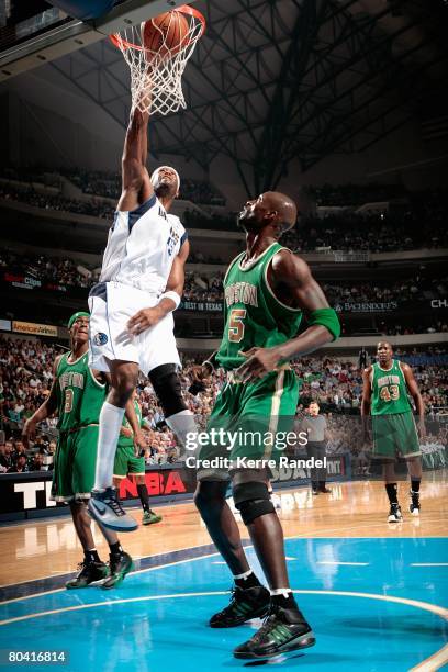 Erick Dampier of the Dallas Mavericks slam dunks over Rajon Rondo and Kevin Garnett of the Boston Celtics during the game on March 20, 2008 at...