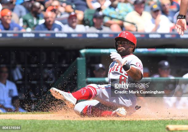 Eric Young Jr. #8 of the Los Angeles Angels of Anaheim slides safely into home plate during the game against the Detroit Tigers at Comerica Park on...