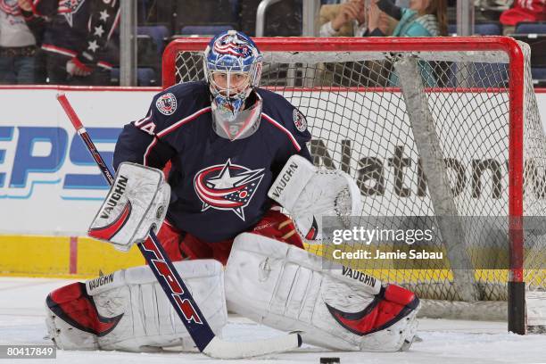 Goaltender Dan LaCosta of the Columbus Blue Jackets takes his turn at the net during pregame warmups before a game against the Chicago Blackhawks on...